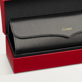 A black leather Cartier Sunglasses case with gold lettering, designed for luxury eyewear like the Cartier Sunglasses CT0550S-008 56, rests inside an open red textured box on a light background.