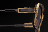 Close-up of Dita Sunglasses HYPERLUX-1000 DTS470-A-02 by Dita Sunglasses, featuring gold and black metal details that highlight exquisite Japanese craftsmanship in the hinge and frame, set against a black background.