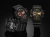 Three CASIO G-Shock GA400GB-1A4 analog-digital watches are displayed on a reflective black surface, featuring bold, rugged designs with accents in rose gold, gold, and white.