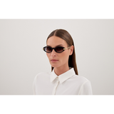 A person with straight, long brown hair wears Cartier Men Sunglasses CT0634S-001 52 and a white collared shirt, posing against a plain light background.