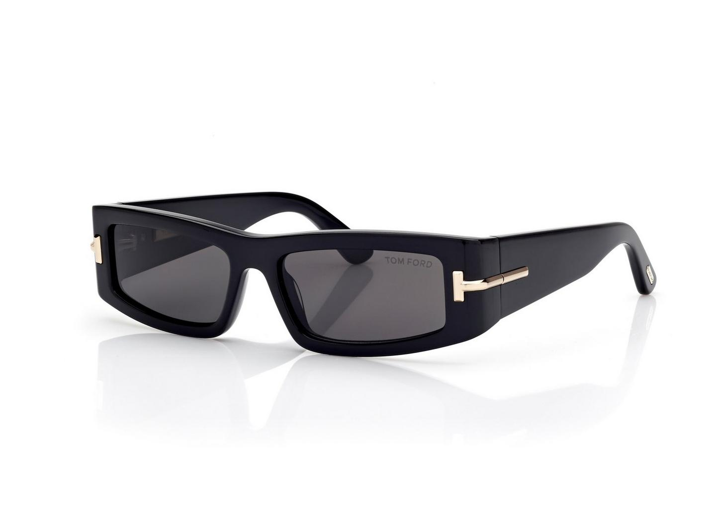 The Tom Ford ICON TI0026/S 01Z sunglasses feature a black rectangular frame, dark lenses, and gold hinge accents—luxury designer eyewear from Tom Ford Sunglasses displayed on a white background.