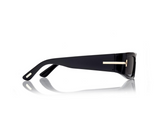 Tom Ford ICON TI0026/S 01Z sunglasses, shown side-on, feature a black rectangular frame with thick arms and subtle gold detailing near the hinge—designer eyewear by Tom Ford Sunglasses on a white background with a faint reflection.