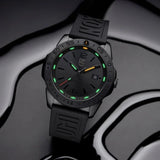 A Luminox Watches Pacific Diver XS.3121.BO.1, featuring a black rubber strap and green luminescent hour markers, rests on a glossy, wavy black surface. This Swiss Made dive watch from Luminox Watches offers 200-meter water resistance, a date display on the face, and subtle branding on both the dial and strap (UPC: 7611382668004).