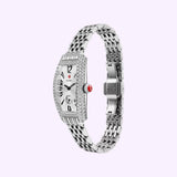 The Michele Watches Special Edition Coquette Diamond Stainless Steel MWW08B000285 is a luxurious silver timepiece featuring a diamond-encrusted bezel and bracelet, a rectangular face with bold black numerals, and Michele Watches’ signature red crown, all elegantly showcased against a light purple background.