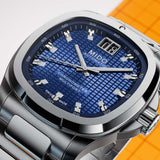 Mido Watches Multifort TV Big Date Chronometer M0495671104100 stainless steel watch with a square-shaped bezel, blue checkered dial, and a large date display at the 12 o’clock position.