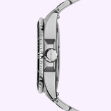 Side view of the Mido Watches Ocean Star 200 M0269301105100 stainless steel automatic dive watch, featuring a textured bezel, visible crown engraved with "MIDO," and a metal strap—set against a light purple background to highlight Swiss precision craftsmanship.