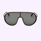 A pair of Moncler ML0222 01A 00 Unisex Metal Sunglasses by Moncler Sunglasses—featuring a large aviator silhouette in black with dark lenses and striking silver accents—exude signature Moncler sophistication while displayed on a plain light purple background. This luxury eyewear offers a timeless, standout style perfect for anyone seeking unisex metal sunglasses.