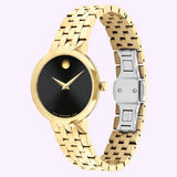 The Movado Watches 0607847 Museum Classic for women is a Swiss-made gold-tone timepiece from Movado Watches. Inspired by the iconic Museum Classic design, it features a minimalist black dial with signature gold hands and a single gold dot at 12 o’clock. The elegant look is completed with a metal link band and a secure silver clasp.