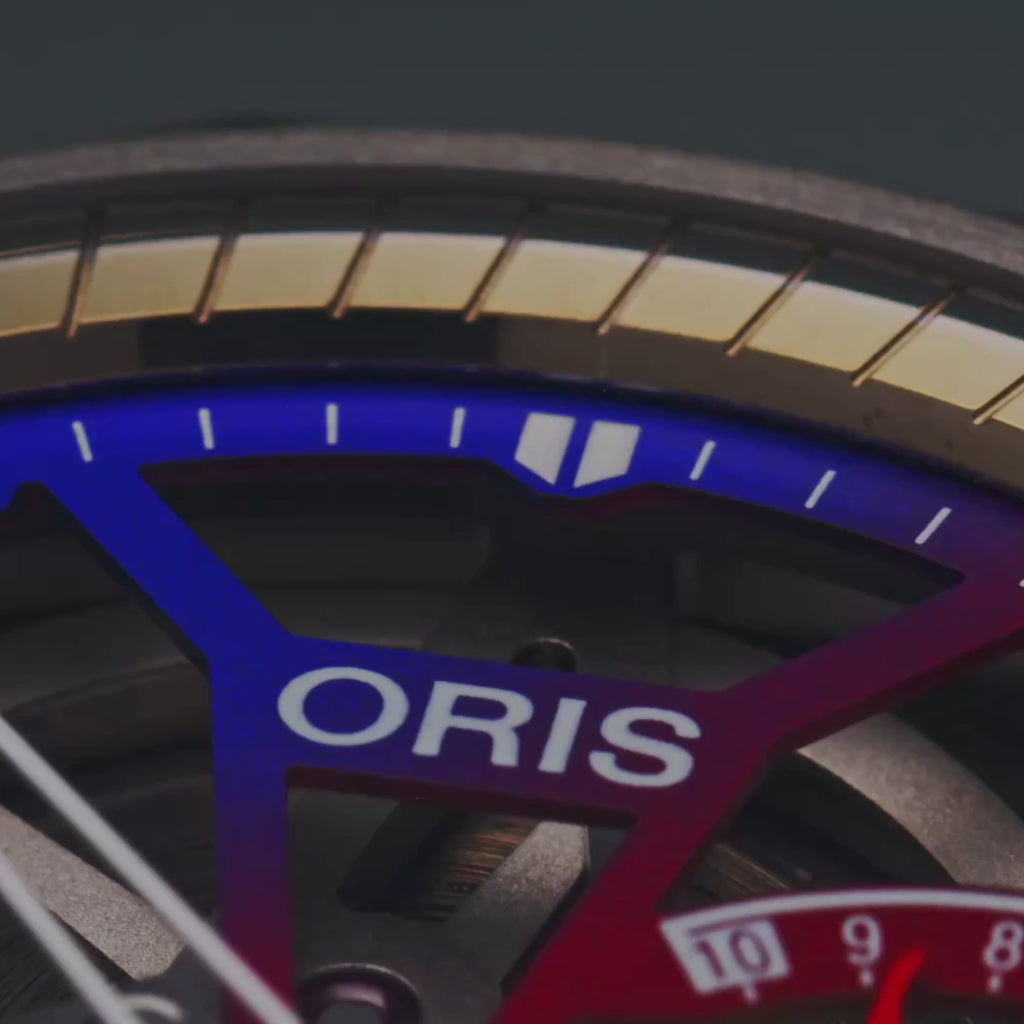 VIDEO The Oris Watches ProPilot X Gonzo Edition 01 115 7759 7180-Set shines on a wrist in a blue shirt, displaying vivid red, blue, orange, and purple gears through its sleek skeleton design and stainless steel band.