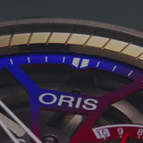 VIDEO The Oris Watches ProPilot X Gonzo Edition 01 115 7759 7180-Set shines on a wrist in a blue shirt, displaying vivid red, blue, orange, and purple gears through its sleek skeleton design and stainless steel band.