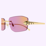 Showcasing the Cartier Sunglasses CT0474S-006 56, this close-up highlights their gradient pink lenses, elegant gold temple arms, and distinctive leopard-print detail near the hinge—a sophisticated piece of luxury eyewear by Cartier Sunglasses set against a pale lavender background.
