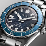 Close-up of a Seiko Luxe Watches Prospex U.S. Special Edition SPB421 dive watch with a textured dark blue dial, silver indices, and a rotating blue bezel on a stainless steel bracelet.