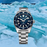 Seiko Luxe Watches Prospex U.S. Special Edition SPB421 stainless steel dive watch with a textured blue dial and blue bezel, set against a background of blue ice shards.