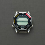 The Seiko Watches 5 Rotocall SMGG17 by Seiko Watches is a digital quartz watch with a silver case, octagonal black bezel, and a textured gray background. The bezel has yellow, white, and red mode labels but does not display the time.