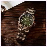 Seiko SPB155 Prospex Baby Alpinist 38mm watch at 45-degree angle showing green dial and steel bracelet