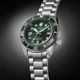 Seiko SPB381 green ceramic unidirectional bezel detail with knurled edge and LumiBrite pearl, top view
