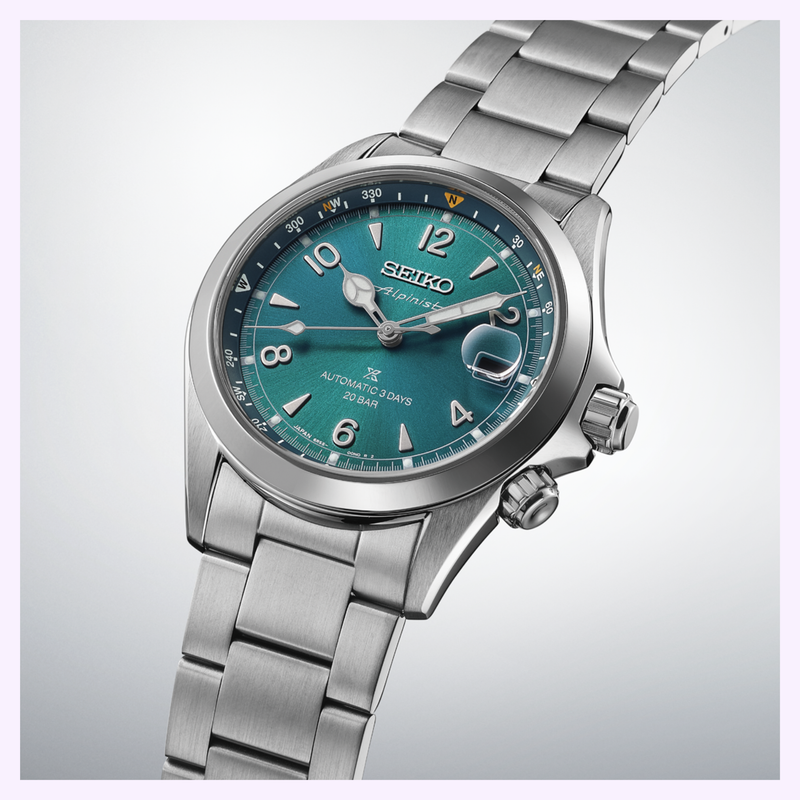 Close-up of Seiko SPB503 Alpinist teal dial with inner rotating compass bezel and gold LumiBrite hands
