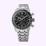 A Seiko Luxe Watches Prospex Speedtimer Mechanical Chronograph SRQ055, crafted in stainless steel with a black dial displaying three subdials and a tachymeter bezel, is showcased on a light background.