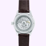 The back view of the Seiko Luxe Watches Presage Green Enamel Limited Edition SPB111 Men’s watch showcases a transparent case that reveals its intricate inner gears, marked with “Limited Edition” and “0001/2000,” and is complemented by a sophisticated brown leather strap.