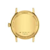 The gold-toned case back of a Tissot T1294103626100 CLASSIC DREAM Men Watches wristwatch, featuring engraved text including water resistance, material specifications, and model numbers.