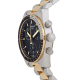 A close-up of the Tissot Watches T1494172205100 TISSOT PR516 CHRONOGRAPH showcases its black dial, gold and silver bezel, and two-tone metal band. This luxury sports watch by Tissot Watches features a Swiss-made chronograph movement and is viewed from the side.