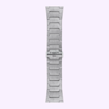 A Tissot Watches PRX Powermatic 80 Steel & 18K Gold Bezel 40mm bracelet is shown vertically on a light lavender background, featuring brushed stainless steel links and a central clasp engraved with TISSOT 1853.