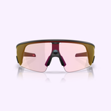 Front view of Oakley Meta Vanguard Sunglasses 0OW8001 800109 by Oakley Meta Sunglasses, featuring a wraparound black frame, pink-tinted lenses, and prominent nose bridge against a light purple background.