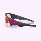 Sleek black Oakley Meta Vanguard Sunglasses 0OW8001 800109 with wraparound design, pink-yellow gradient lens, and subtle Oakley logo, displayed on a light purple background.