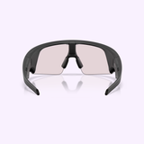 The Oakley Meta Vanguard Sunglasses 0OW8001 800109 are sporty, wraparound AI glasses from Oakley Meta Sunglasses, featuring black frames and lightly tinted wide lenses, displayed front-facing against a pale background.