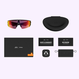 Oakley Meta Vanguard Sunglasses 0OW8001 800109 with red-tinted lenses, black case, envelope, two instruction cards, lens cleaning cloth, and small black pouch on a light purple background. From Oakley Meta Sunglasses.