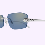Close-up of Cartier Sunglasses CT0474S-005 UNISEX: Elegant blue-tinted lenses, silver arms, and stylish white temples with black Dalmatian print detail near the hinge.