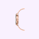 Side view of the Mido Watches Commander Datoday M0214303309100 in rose gold, with a slim case, metal link band, and sapphire glass, set against a light lavender background.