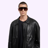 A person with short hair wears Carrera Sunglasses FLAGLAB 17 2M2 (UPC 197737075071), a black t-shirt, and a leather jacket against a plain light background, capturing the style of authentic Carrera Sunglasses.