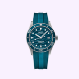 The Mido Watches Ocean Star 39 M0269071104101 is a Swiss automatic dive watch with a round stainless steel case, blue dial with white markers, date at 3 o’clock, rotating bezel, and matching teal rubber strap.
