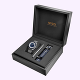 The Mido Watches OCEAN STAR GMT M0268291804100 gift set comes in a black box with the Mido logo, featuring a Swiss automatic dive watch with blue and silver dial, metal strap, extra striped fabric strap, and a strap-changing tool.