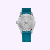 The back of the Mido Watches Ocean Star 39 M0269071104101 dive watch features an engraved compass design and inscriptions on the stainless steel case back, paired with a stylish teal silicone strap.