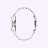 A side view of the Bulova Watches Surveyor 96B429 men's watch with a linked stainless steel band and visible crown, shown against a light purple background.