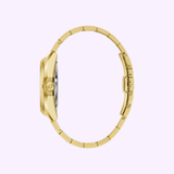 The Bulova Watches Surveyor 97A182 Men, shown from the side against a light purple background, features a round gold-tone case, slim metal band, and elegant automatic 21-jewel movement.