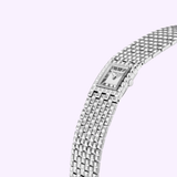 The Frederique Constant Classics Manchette FC-200WR1MC6B women's watch features a silver rectangular face, Roman numeral hour markers, and a textured stainless steel bracelet, shown against a pale lavender background.