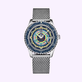 The Mido Watches SPECIAL EDITION OCEAN STAR DECOMPRESSION WORLDTIMER M026.829.17.041.00 features a silver mesh band, a multicolored concentric circle dial with city names and GMT, shown on a light purple background.