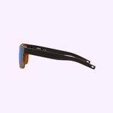 The Costa Del Mar Sunglasses 900818 Spearo Matte Black feature a sleek matte black frame and blue polarized glass lenses, displayed from the side on a light purple background—highlighting Costa Del Mar Sunglasses’ signature style.
