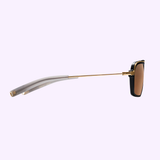 Side view of Dita Sunglasses DLS404-56-01-A LSA-404 featuring a thin gold metal arm, translucent gray temple tip, and rectangular brown polarized lenses in a black and gold frame, displayed on a light purple background.