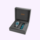 A Mido Watches Ocean Star 39 M0269071104101 gift box featuring a 39mm Swiss automatic dive watch with a silver case and blue dial on the left, plus an extra blue strap on the right, displayed in a gray box with the Mido logo inside the lid.