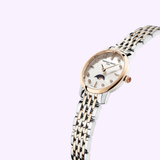 The Frederique Constant Classics Slimline Ladies Moonphase FC-206MPWD1S2B features a silver and rose gold band, diamond mother-of-pearl dial, gold markers, and moon phase display, showcased on a pale lavender background.