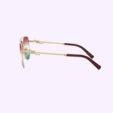 Tiffany & Co. Sunglasses 0TF3116 6230EL59 for women feature gold-toned frames with red-tinted lenses and deep red arm tips, elegantly showcased from a side view against a pale purple background—a sophisticated choice from Tiffany & Co. Sunglasses to enhance any women's eyewear collection.