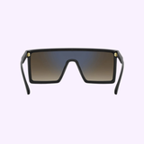 Carrera Sunglasses VICTORY C 07/S 7C5 feature black oversized square frames, gradient lenses, and gold hinge accents. Shown on a light purple background. Shop now from your trusted Miami authorized dealer.