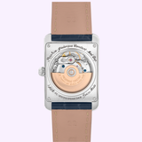 Close-up of the Frederique Constant Watches Classic Carre Automatic Leather FC-303N4C26, featuring its mechanical movement, rose gold rotor, engraved caseback details, and stitched beige leather strap.