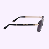 Side view of Police SPL890 301P aviator-style men’s sunglasses by Police Sunglasses with rose gold frames and dark lenses, featuring a gold winged emblem on the temple. Shown against a light purple background.