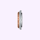 Side view of the Tissot Watches PRX Powermatic 80 Steel & 18K Gold Bezel 40mm (T9314074129100) with a rose gold bezel and silver frame, set against a light purple background—ideal for Swiss automatic watch enthusiasts.