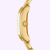 A side view of the Tory Burch Watches THE ELEANOR TBW1060 women’s watch showcases its textured gold-tone bracelet and round crown against a light purple background. The polished and smooth case highlights the elegant craftsmanship characteristic of Tory Burch Watches.